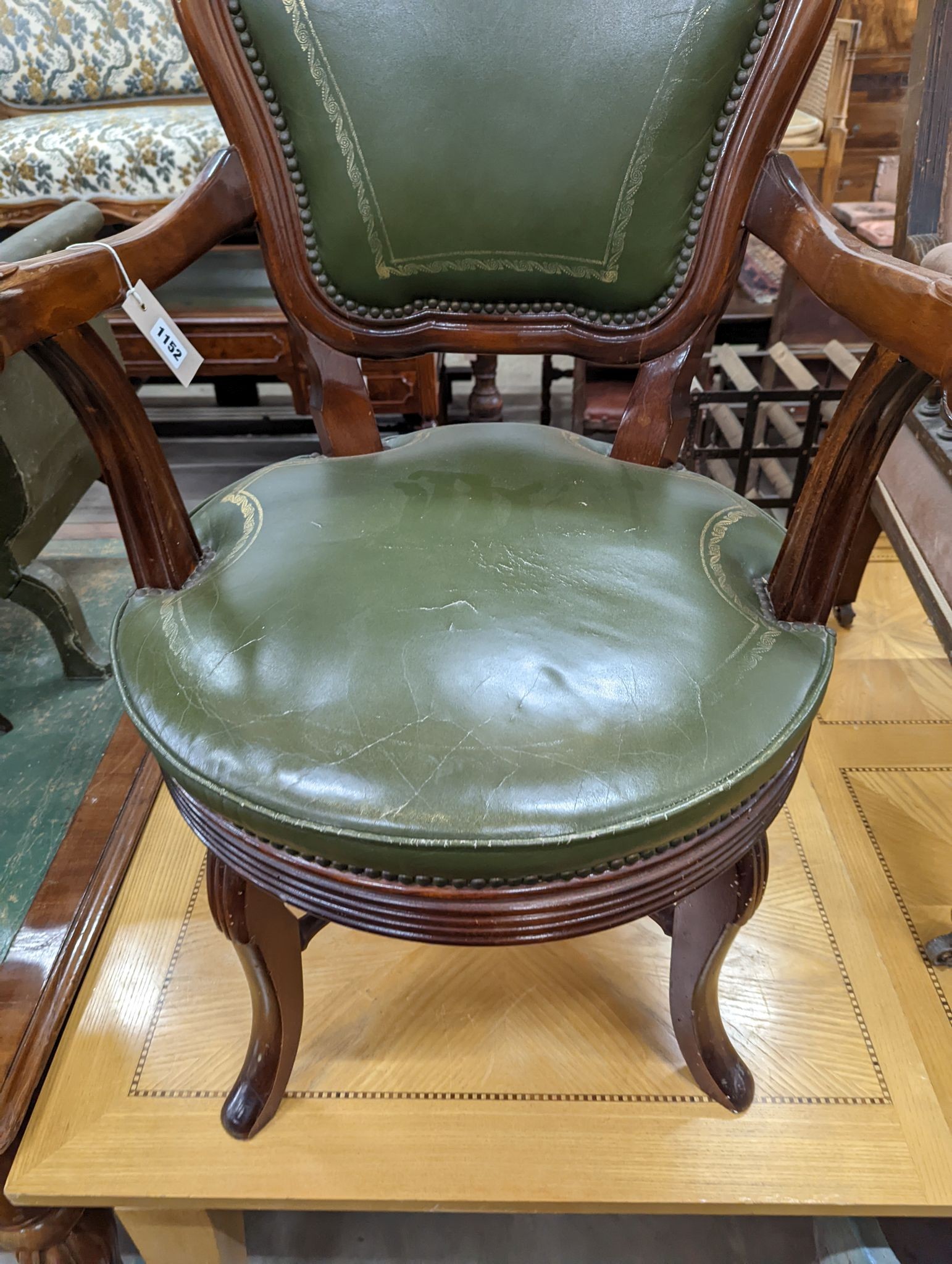 A Victorian style mahogany and green leather swivel desk chair, width 60cm, depth 50cm, height 96cm